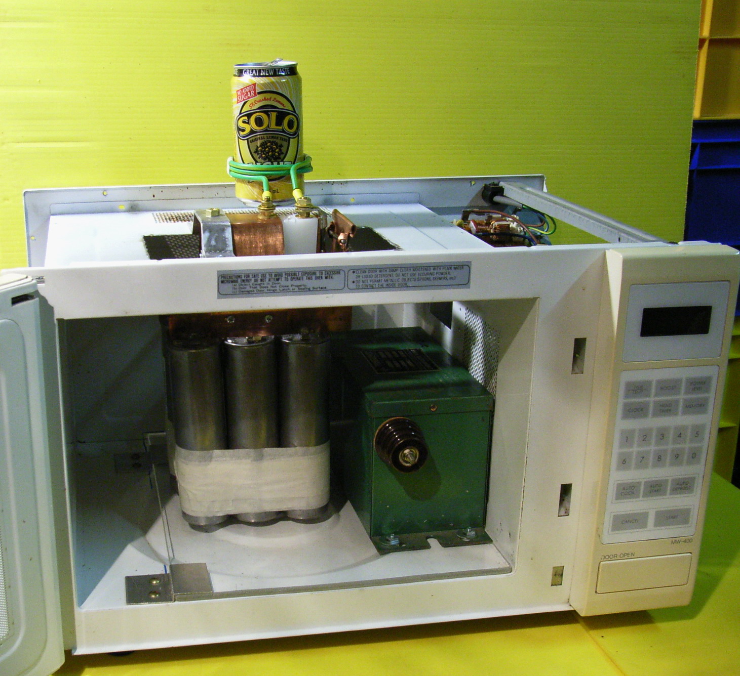 The neat arrangement of the caps inside a cut out microwave oven