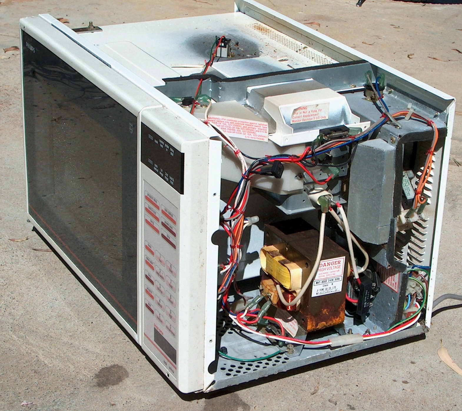 A scrap microwave oven with cover off.