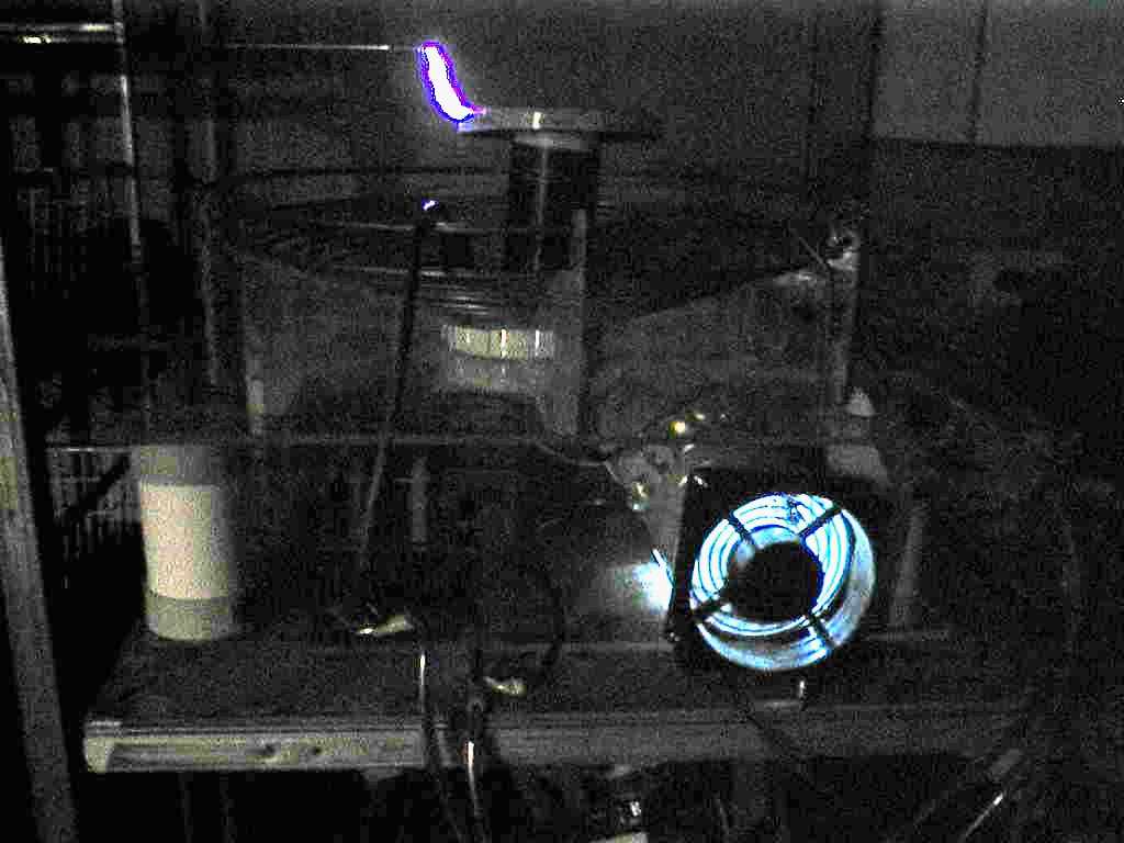 One of my earliest tests of the 4 inch diameter coil in development taken in low light with a 2003 camera.  Tesla Coil 4-Inch Version 1