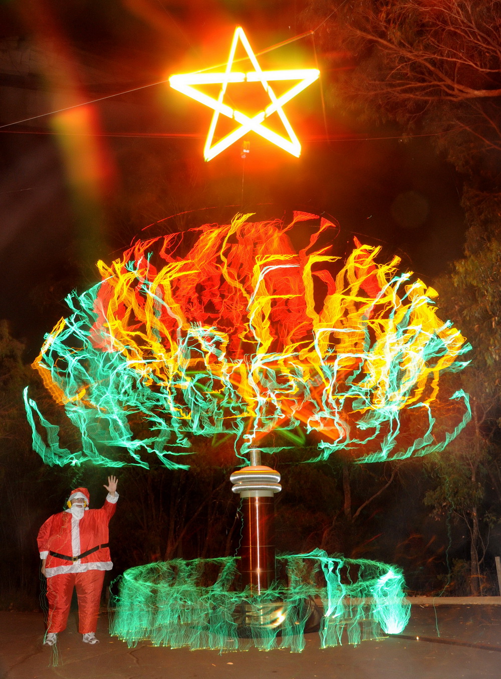 Christmas 2009 Xmas tree created with Tesla coil sparks and a fat blow-up Tesla coil suit.